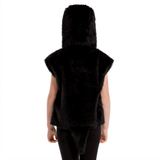 A person wearing a black furry hooded jacket stands facing away from the camera.