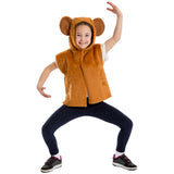 A young girl wearing a brown bear costume with a hood and ears, smiling and posing with her arms raised.