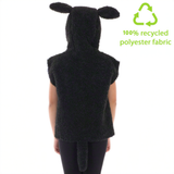 A person wearing a black hooded garment with ears, standing against a white background.